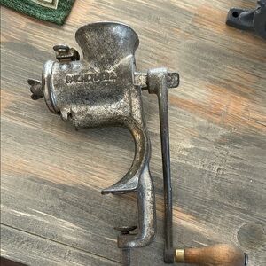 Old meat grinder says Russellerwin 
Or Russwin . Clamps to table top